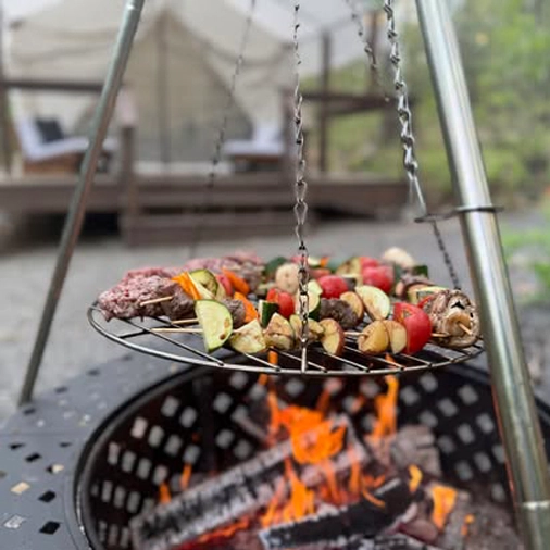 kabobs cooking over a campfire on skewers at rustic acres rv resort and campground
