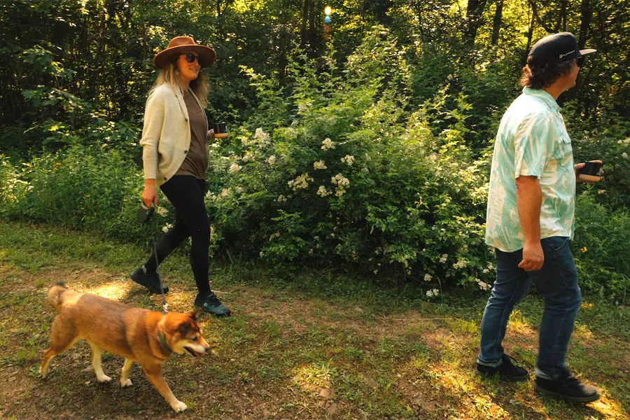 couple walking their dog at rustic acres rv resort